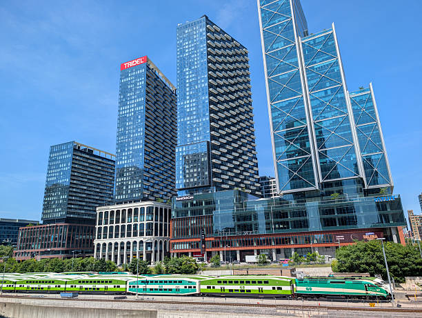 Toronto, Ontario - July 23, 2025: GO Transit commuter trains, The Well mixed use development and other buildings on Front Street West