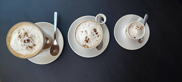 three different types of coffee, espresso, cappuccino, and latte served outdoors at a ?afe in Portugal. Concept of the countrys coffee culture and beverage themes.