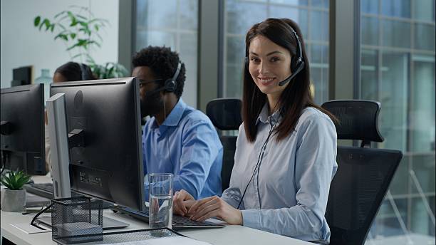 istock Helpline callcenter multiethnic business workers working online computer office customer service call center diverse smiling Caucasian Indian women African man in headset speak work pc helping client 2226713569