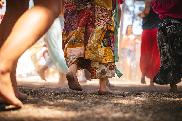 Group of hippies dancing barefoot at a festival