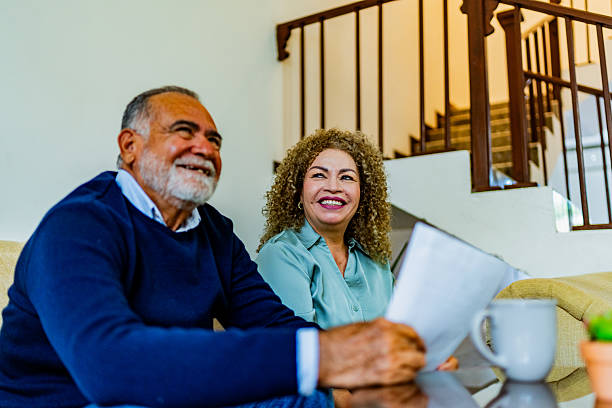 istock Happy senior couple holding document at home 2226718710