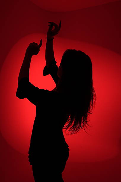 istock Silhouette of a Woman Dancing in Red Light 2226719207
