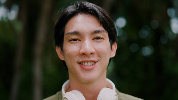 istock Young Asian man taking a short rest from a morning exercise in a public park. 2226726428