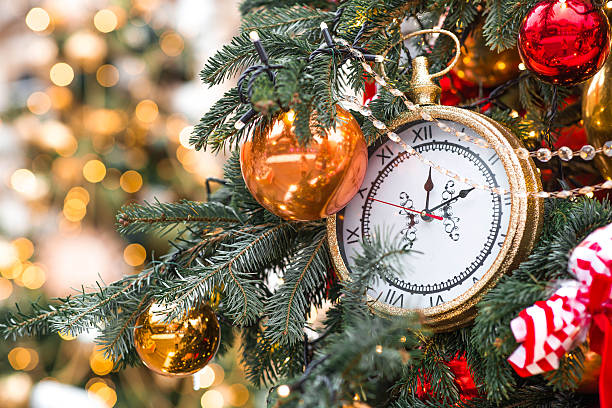 istock The clock hands on the dial show 12 o'clock. Golden retro clock on a Christmas tree. Beautiful background for New Year's Eve or Christmas 2026. 2226726461