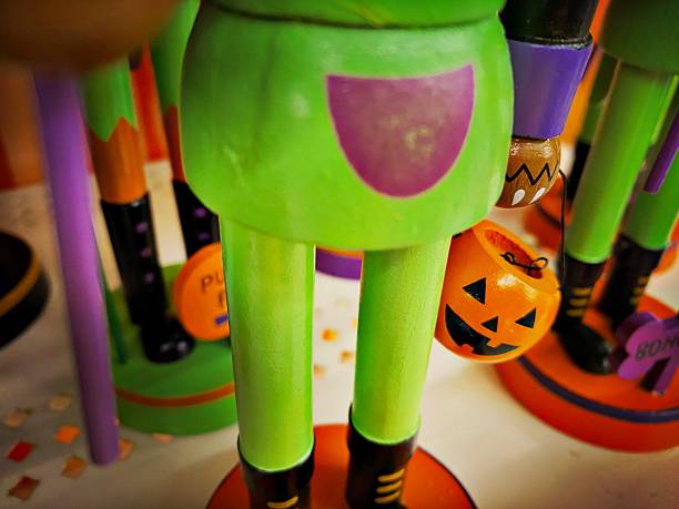 Bozo ghost wooden doll in Halloween pumpkin lantern with space on swimming pool background, outdoor day light, Happy halloween background idea