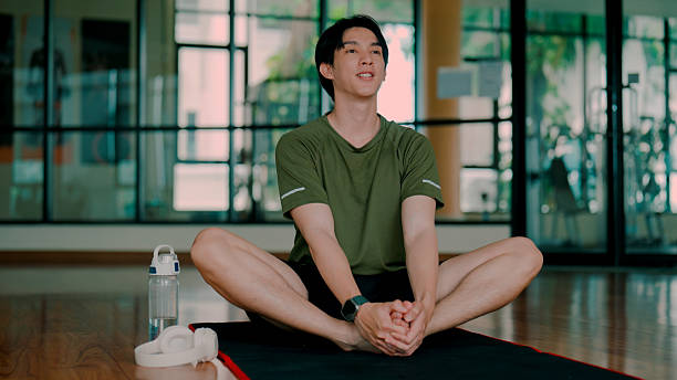 istock Young Asian man doing a butterfly pose to build body flexibility. 2226727932
