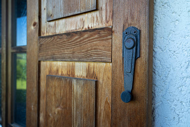 Wooden window shutter with vintage metal latch on a country house