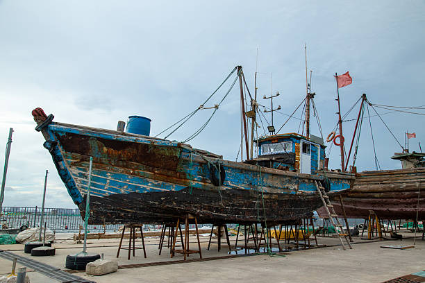 istock Old Fishing Boat on Dry Dock with Rust and Paint Flaking 2226731431
