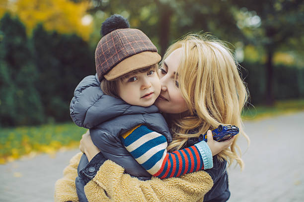 istock Loving Mother Hugging Her Son Outdoors in Autumn Park 2226731510