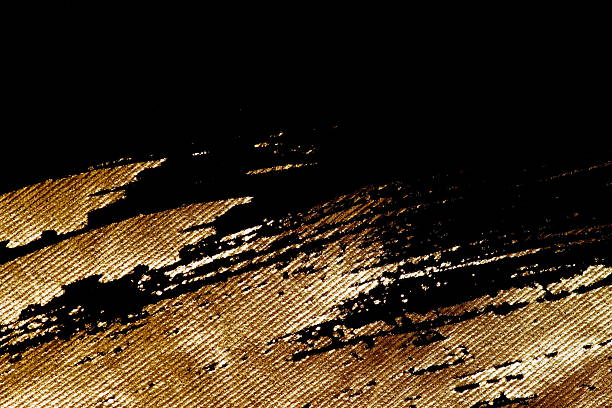 Abstract background brush gold painting texture on black fabric. Copy space. Painting background.Holiday, Christmas backdrop, mockup, template.