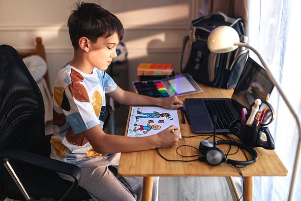 istock boy drawing himseelf and his dad playing together while waiting for him to come from work 2226731908