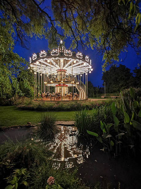 istock Illuminated Vintage Carousel Reflected in a Pond at Night 2226733970