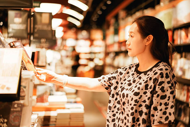 istock A woman browsing books in a well-lit bookstore 2226742885