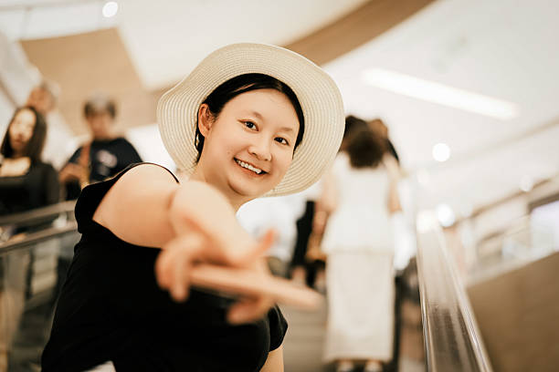istock A young woman wearing a hat pointing her finger in an indoor setting 2226743117