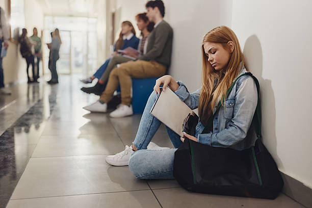 istock Female student relaxing on floor during a break in a hallway. 2226744262