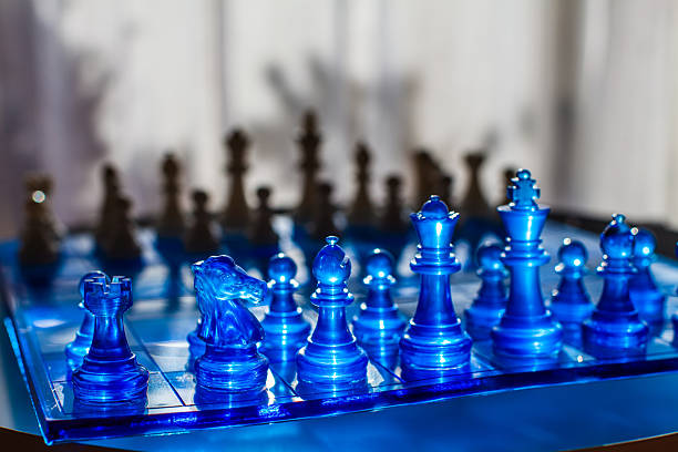 istock A vibrant chessboard features translucent blue pieces in sharp focus, contrasting with blurred wooden pieces in the background 2226749200