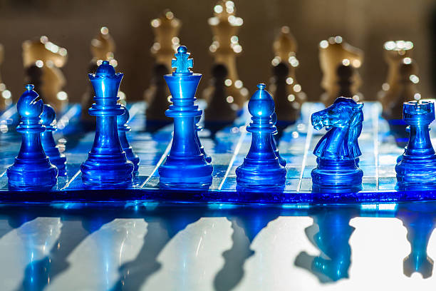 istock A striking chessboard scene featuring translucent blue and golden pieces, with a shallow depth of field 2226749515