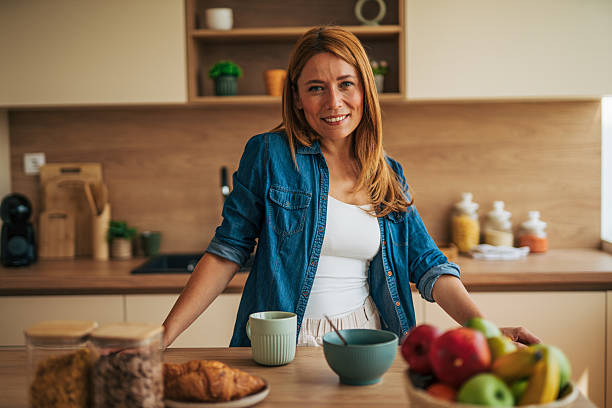 istock Smiling woman enjoying a healthy breakfast in her modern kitchen 2226750187