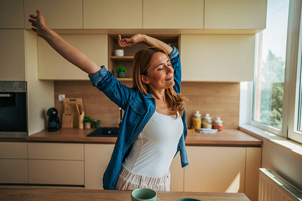 istock Woman stretching in kitchen after waking up 2226750470