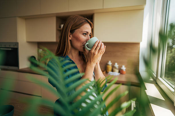 istock Serene woman enjoying a hot beverage in her modern kitchen 2226750793