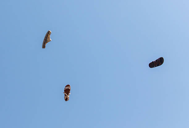 Freefall jumpers face each other mid-air lofty clouds