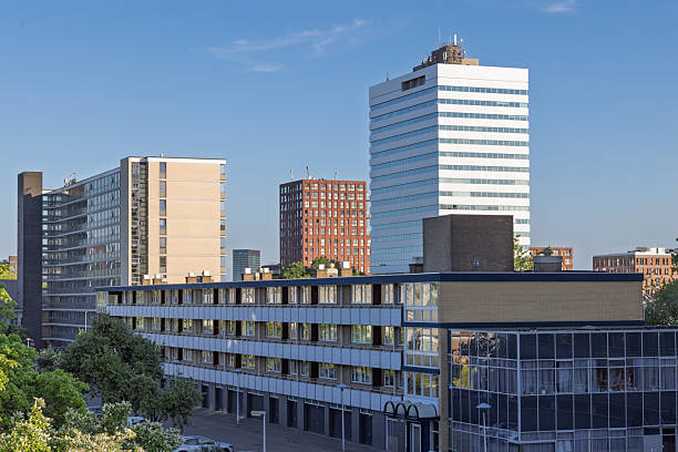A modern urban skyline featuring a prominent white high-rise, various apartment blocks, and lower buildings, Kanaleneiland Utrecht, Netherlands.