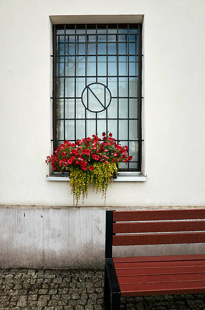 istock Window with a potted plant and a bench outside 2226753425