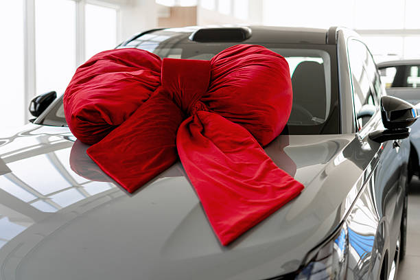 istock Giving a car as a gift with a large red bow 2226755005