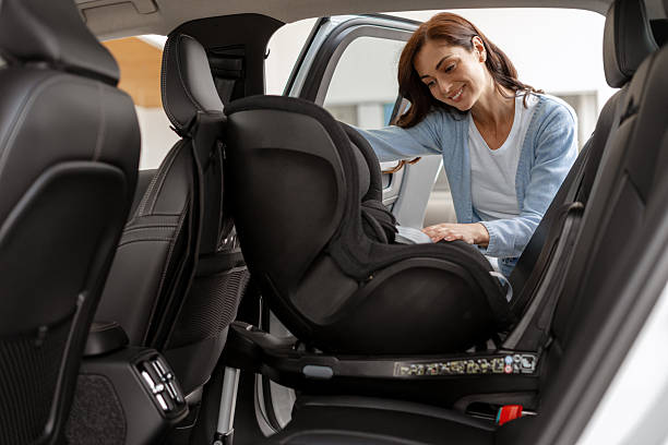 istock Mother Installing Child Safety Seat in Car 2226757017