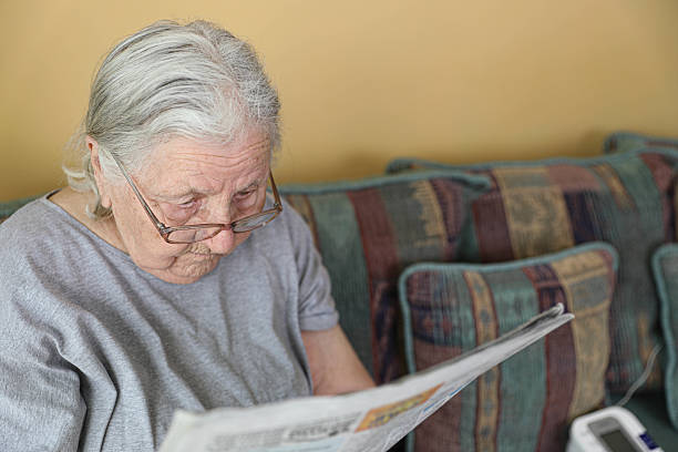 istock Retired Woman Reading Newspaper at Home 2226759269