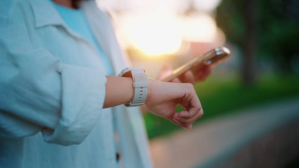 istock Syncing a fitness tracker to a smartphone before jogging outdoors 2226760373