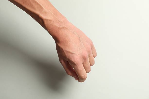 istock Man with bulging veins on his arm against light background, closeup 2226761995