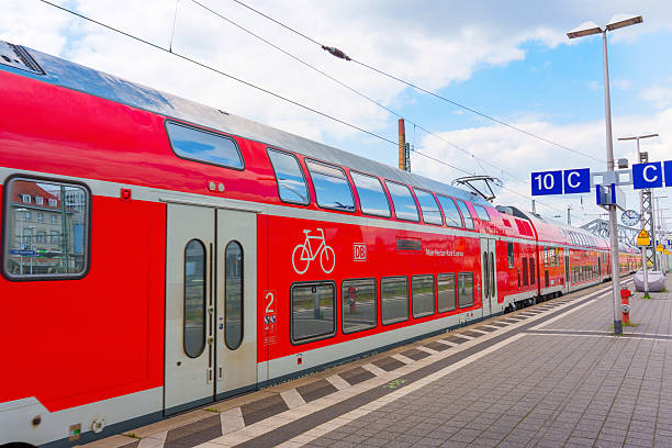 Darmstadt, Germany - June 16, 2025: Close-up view of a red double-decker train parked at Darmstadt railway station, featuring a bicycle symbol, capturing urban transportation and modern infrastructure