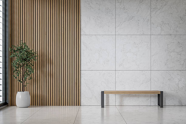 istock A modern office interior with a wooden bench on tiled floor, window and decoration in front of half marble half hardwood slat 2226763723