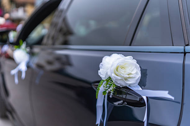 istock White roses decorating a wedding car door handle 2226767291
