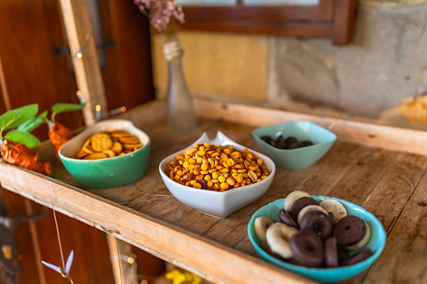 Colorful candy and snacks arranged on a rustic wooden tray, creating an inviting display for a joyful wedding celebration
