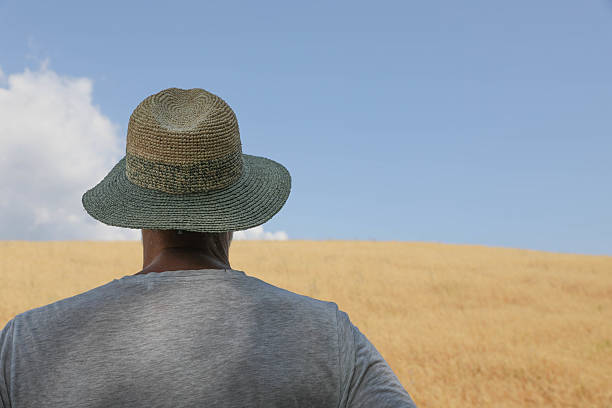 istock Man in Straw Hat Facing Open Farmland 2226767541