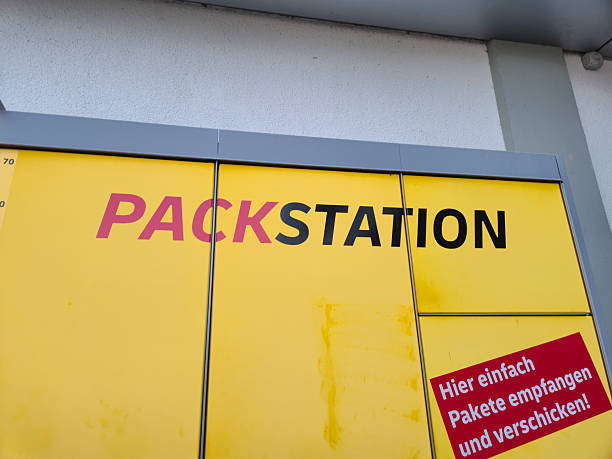 Lahde, Germany - April 15 2025: A vibrant PACKSTATION sign on a yellow background, indicating a parcel collection point, showcasing convenience in urban logistics.