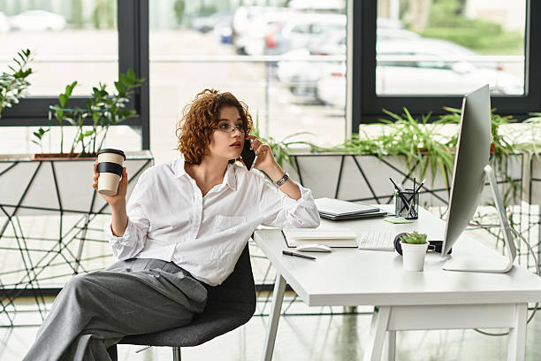istock Young businesswoman discusses work over coffee in a modern office 2226779601