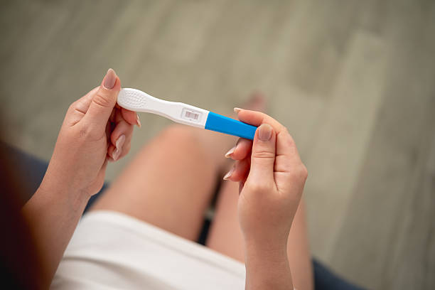 istock A woman holds a pregnancy test with two stripes in her hands 2226780554