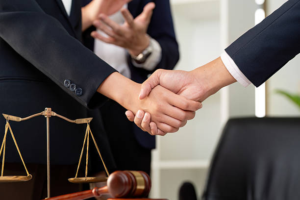istock Legal Collaboration. Professionals discussing case strategy with handshake in law office. 2226780609