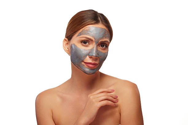 istock Young woman applying a purifying clay mask to her face 2226782636