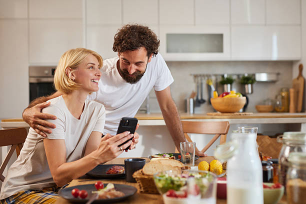 istock Happy couple enjoying a cozy breakfast together in their modern kitchen while 2226789042