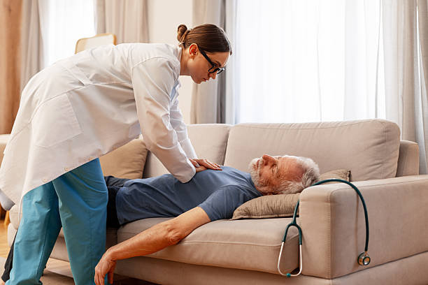 istock Doctor performing cpr on senior man lying on sofa at home 2226789748