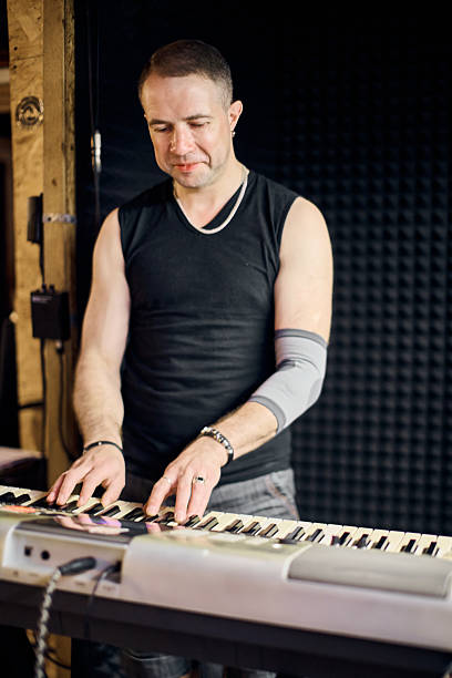 istock Male keyboardist in intense studio rehearsal session 2226791200