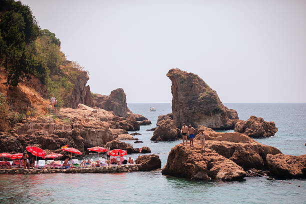 August 04, 2024 Turkiye Antalya Kaleici public beach.A group of tourists on a Turkish beach.