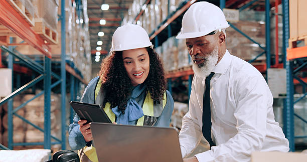 istock Distribution, people and teamwork in warehouse, laptop and online schedule for shipping. Employees, logistics and meeting with safety, stock or tablet for email, industry and checklist with inventory 2226792443