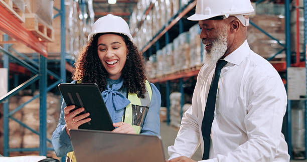 istock Distribution, supply chain and people in warehouse, tablet and online schedule for shipping. Employees, smile and meeting with safety, connection and laptop for email, inventory and quality assurance 2226792453