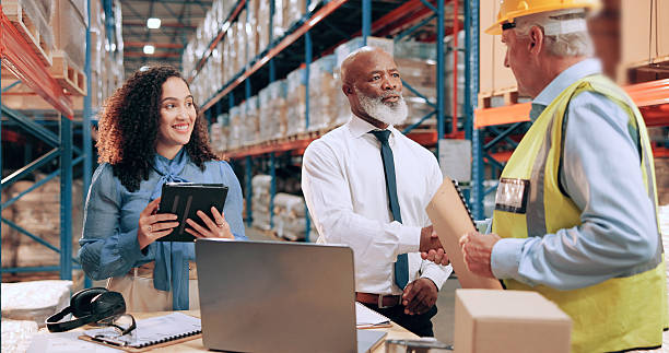 istock Business people, document and handshake in warehouse for logistics, meeting for supply chain collaboration. Import team, tech or shaking hands in storage for export deal, service agreement or welcome 2226792465