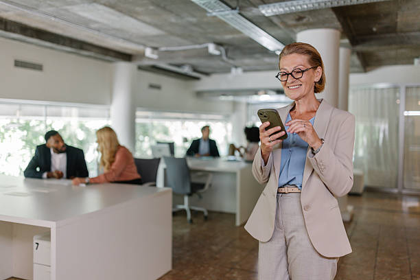 istock Professional woman engaging with smartphone in office 2226793703